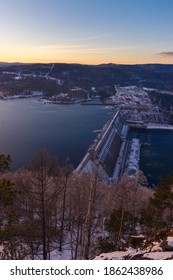 Hydroelectric Power Station On The Yenisei River In Siberia Near Krasnoyarsk In The Glow Of The Sunset