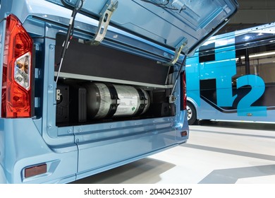 A Hydrogen Fuel Cell Buses. One Bus With An Open Hood And A Hydrogen Cylinder Inside.