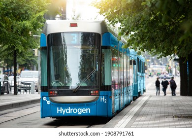 A hydrogen fuel cell tram stands at the station