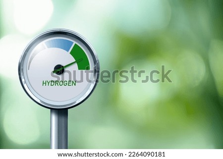 Hydrogen gauge with tree colors - gray, blue and green. Arrow points to green. Concept of green hydrogen production.