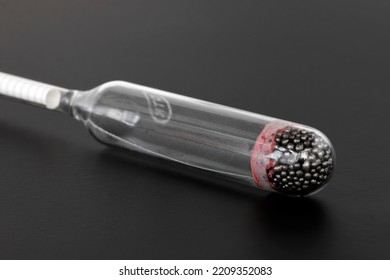 hydrometer, a tool for measuring the density of the battery electrolyte, on a black background