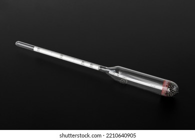 hydrometer, a tool for measuring the density of the battery electrolyte, on a black background