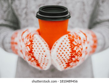 Hygge Concept Close Up Photo With Copy Space Woman In Warm Gray Sweater And Wool Mittens Is Holding Red Paper Cup With Hot Coffee