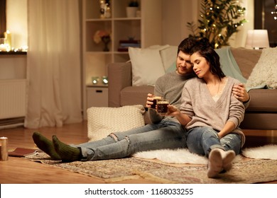 Hygge, Leisure And People Concept - Happy Couple Drinking Coffee And Eating At Home