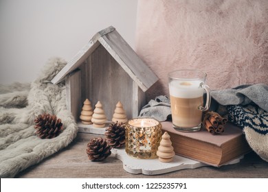 Hygge Scandinavian Style Concept With Latte Macchiato Coffee Cup, Candles And Book. Cozy Winter Or Christmas Composition