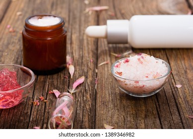 hygiene, beauty products, pink soap, cream, bath salt, tincture, old wooden table background - Shutterstock ID 1389346982