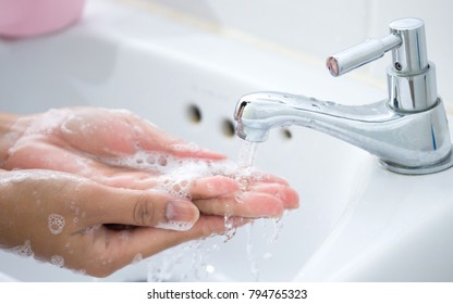 Hygiene. Cleaning Hands. Washing hands with soap under the faucet with water Pay dirt. - Shutterstock ID 794765323
