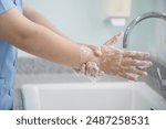 Hygiene and cleaning hands.Washing hands rubbing with soap for corona virus prevention, hygiene to stop spreading coronavirus.Close up woman hand washing in the kitchen.