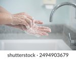 Hygiene and cleaning hands.Washing hands rubbing with soap for corona virus prevention, hygiene to stop spreading coronavirus.Close up woman hand washing in the kitchen.