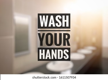 Hygiene Concept. Wash Your Hands Text Over Blurred Perspective Of Restroom Sinks Interrior.