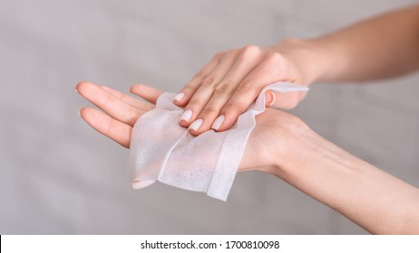 Hygiene During Epidemic. Girl Wipes Hands With Antiseptic Napkin
