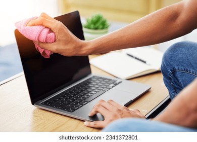 Hygiene, laptop and closeup of man cleaning his screen to prevent dust, dirt or germs at his desk. Technology, health and male person wipe computer with a cloth for sanitizing or disinfection at home - Powered by Shutterstock