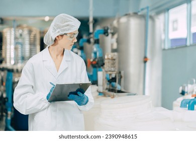 hygiene staff worker in foods and drinks clean factory. working women in water plant industry quality control check. - Powered by Shutterstock