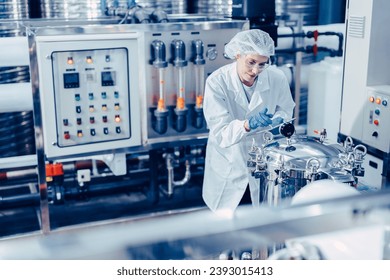 hygiene staff worker in foods and drinks clean factory. working women in water plant industry quality control check. - Powered by Shutterstock