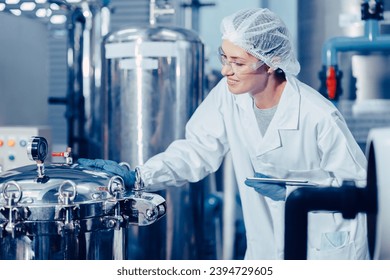 hygiene staff worker in foods and drinks clean factory. working women in water plant industry quality control check. - Powered by Shutterstock