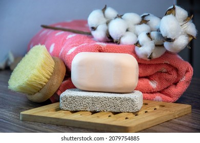 Hygiene Supplies For Bath And Spa Treatments On A Wooden Background. Cotton, Natural Body Brush, Towel, Soap And Pumice.