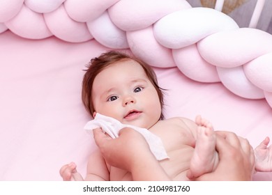 Hygiene - Young Mom Wiping The Baby Skin Body And Face With Wet Wipes Carefully On Pink Background. Concept Cleaning Wipe, Pure, Clean.