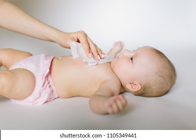 Hygiene - young momy wiping the baby skin with wet wipes. Cleaning wipe, pure, clean