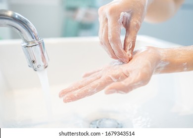 Hygiene,Hands of child girl rubbing her hands,washing frequently with an antiseptic soap,protection against viruses and bacteria infection,cleaning hand to stop spread of Covid-19,Coronavirus pandemic - Shutterstock ID 1679343514
