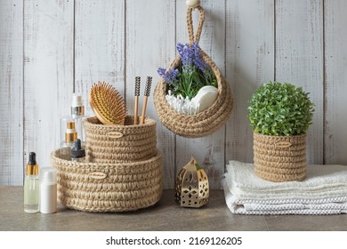 Hygienic Accessories For Bath And Spa On The Table In The Bathroom. Wooden Hairbrush, Towel And Green Leaves. Eco Containers For Order In The Bathroom