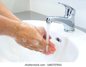 Hygienic concepts Wash your hands with soap under the tap with clean water for protection against viruses. - Shutterstock ID 1685707810