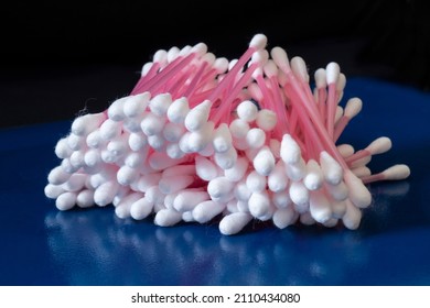 Hygienic cotton swabs on a blue table. Medical items on a black background