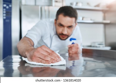 Hygienic Precautions. Worker In Restaurant Kitchen Cleaning Down After Service. Selective Focus On His Hand