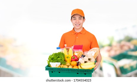 Hygienic Smiling Asian Man Carrying Supermarket Grocery Tray Box Offering Home Delivery Service