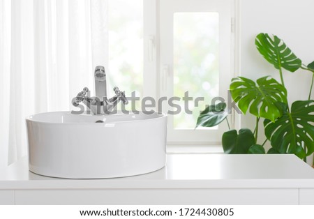 Hygienic wash basin with chrome faucet on bathroom window background