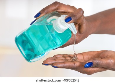 Hygiens concept african woman's hands using Hand sanitizer - Powered by Shutterstock