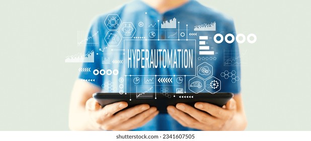 Hyperautomation theme with young man using a tablet computer