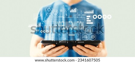 Hyperautomation theme with young man using a tablet computer