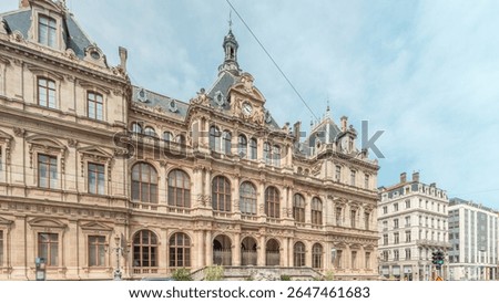 Hyperlapse of Palais de la Bourse (Palais du Commerce) front view in the Les Cordeliers quarter, Lyon, France. A historic 19th-century building with traffic passing on the street timelapse