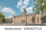 Hyperlapse of Rotterdam City Hall (Stadhuis van Rotterdam) at Coolsingel. One of the few historic buildings in the city center timelapse. Traffic and people on the street, cloudy blue sky. Netherlands