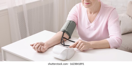 Hypertension. Mature Woman Checking Her Blood Pressure With Tonometer At Home, Panorama With Free Space