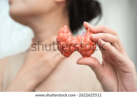 Hyperthyroidism, Overactive Thyroid, Thyroid Lymphoma, Asian woman with thyroid gland human anatomy model.