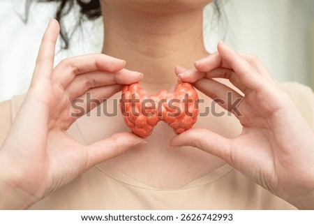 Hyperthyroidism, Overactive Thyroid, Thyroid Lymphoma, Asian woman with thyroid gland human anatomy model.
