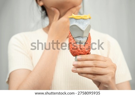 Hyperthyroidism, Overactive Thyroid, Thyroid Lymphoma, Asian woman with thyroid gland human anatomy model.