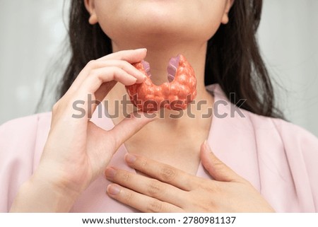 Hyperthyroidism, Overactive Thyroid, Thyroid Lymphoma, Asian woman with thyroid gland human anatomy model.