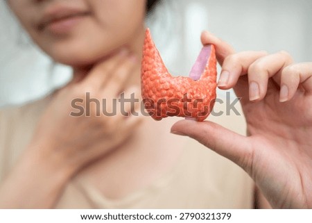 Hyperthyroidism, Overactive Thyroid, Thyroid Lymphoma, Asian woman with thyroid gland human anatomy model.