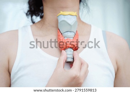 Hyperthyroidism, Overactive Thyroid, Thyroid Lymphoma, Asian woman with thyroid gland human anatomy model.
