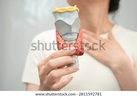 Hyperthyroidism, Overactive Thyroid, Thyroid Lymphoma, Asian woman with thyroid gland human anatomy model.