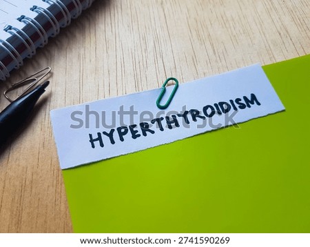 Hyperthyroidism writting on table background. 