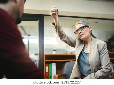 Hypnosis, therapy and relax with people in office for counseling, anxiety management and psychology. Attention, clock and mindset with mature woman and pendulum for hypnotherapy and mental health - Powered by Shutterstock