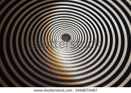 Hypnotic Black and White Spiral Pattern, backdrop. Close-up view of concentric black and white spiral creating an optical illusion, delusion poster. Abstract backgrounds concept. Copy ad text space