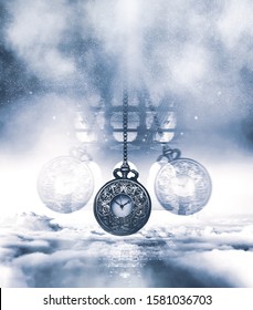 Hypnotising watch on a chain swinging above clouds. Time concept. Blue tones and vertical framing