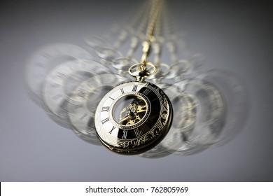 Hypnotism concept, gold pocket watch swinging used in hypnosis treatment
