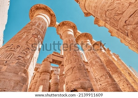 Hypostyle Hall with huge columns in Karnak temple in the famous city of Luxor. Travel attractions and heritage in Egypt