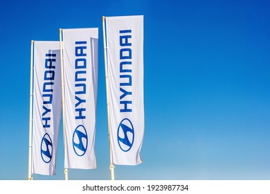 Hyundai Car Dealer Emblem And Logo On Flags In Blue Sky, Moscow, 18 Feb 2021