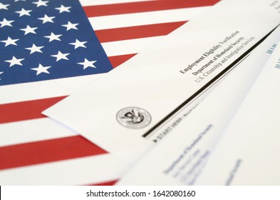 I-9 Employment Eligibility Verification blank form lies on United States flag with envelope from Department of Homeland Security - Shutterstock ID 1642080160